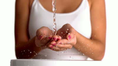 stock-footage-water-pouring-into-womans-hands